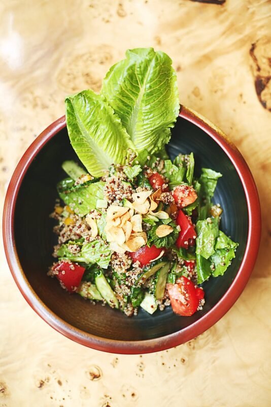 green vegetable salad on red bowl