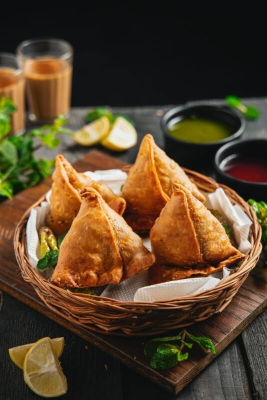 samosas in wicker basket on dinner table