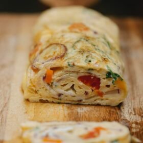 yummy vegetable egg roll cut on wooden board