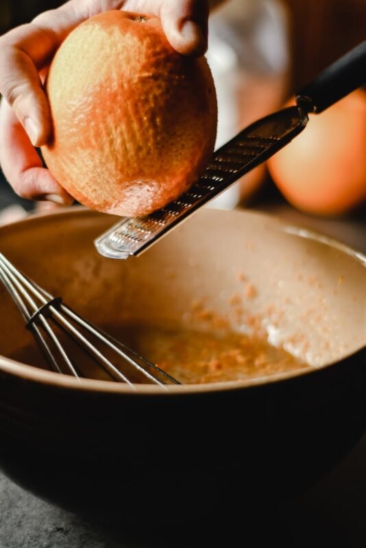 person holding a stainless grater