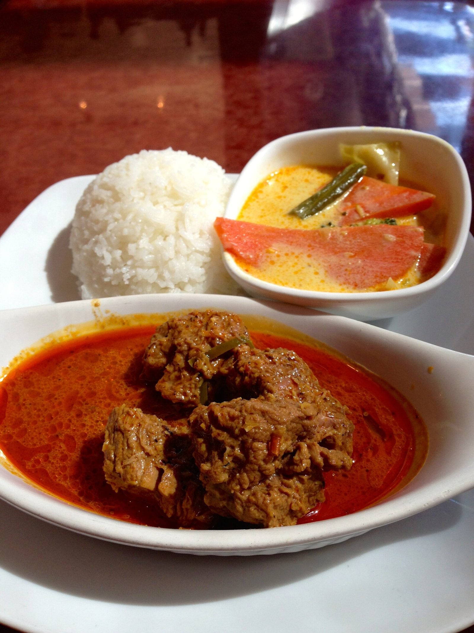 Rendang Beef curry served with coconut milk braised vegetables and rice