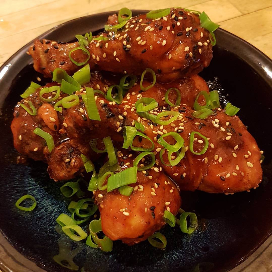 Crisp baked chicken drumsticks with a honey-Sriracha sauce