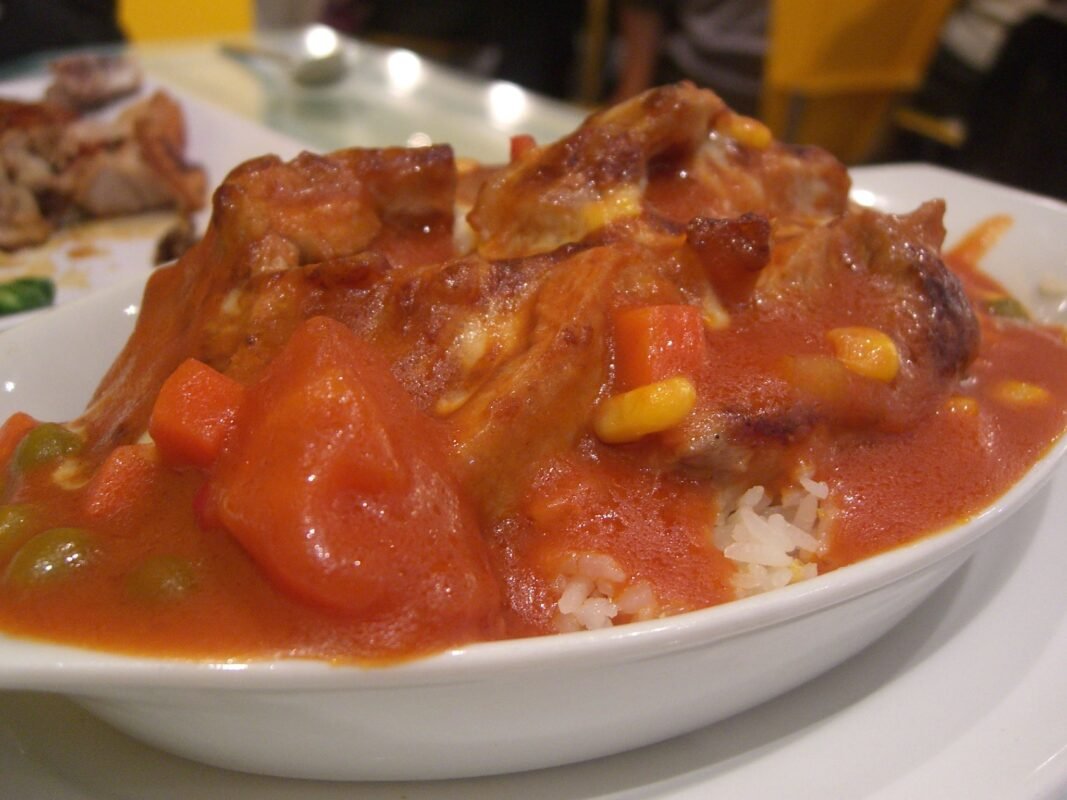 Baked pork chop in tomato sauce on rice