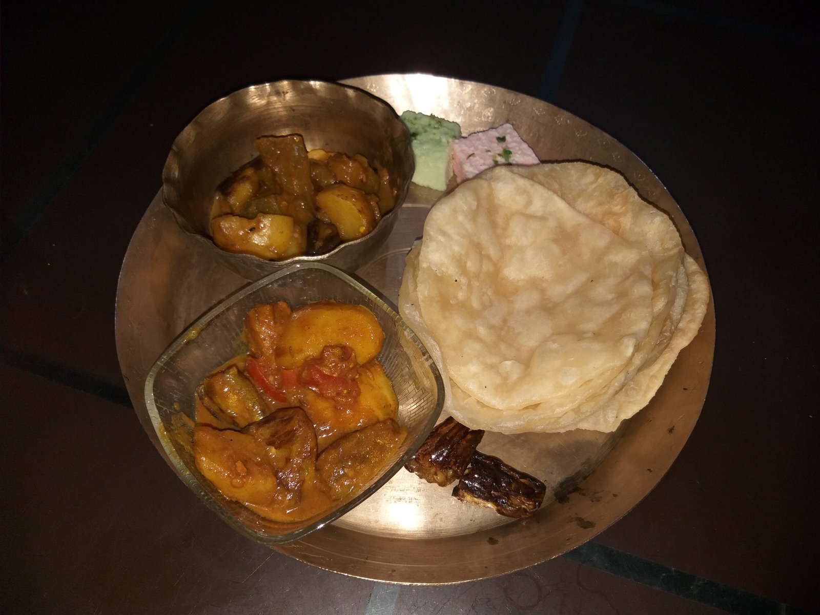 Luchi and vegetable curry alongside Sandesh (sweets)