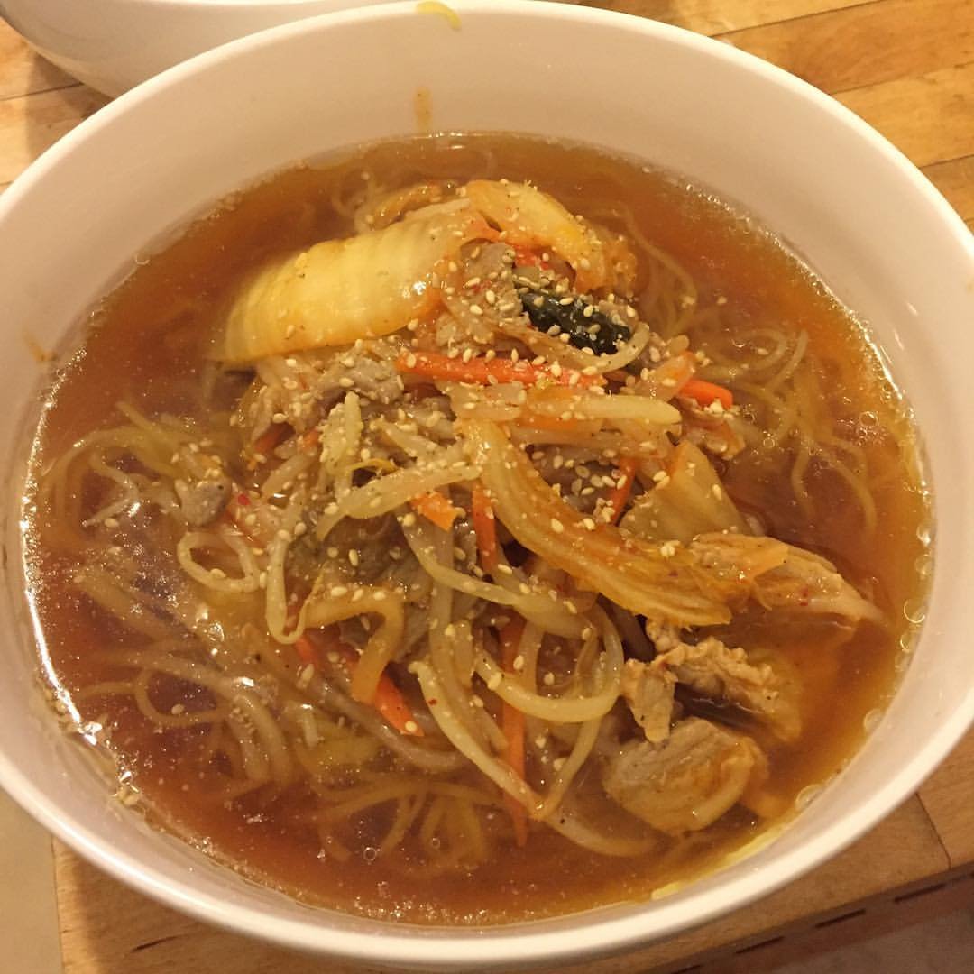Ramen in soy sauce soup with stir fried bean sprouts, kimchi, carrots, and pork