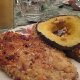 Nut-crusted tilapia with acorn squash rings and pine nuts